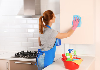 Poster - Woman cleaning kitchen with rag, indoors