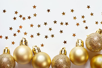 Golden christmas balls on white background. New year decorations.