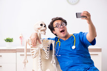 Funny Doctor With Skeleton In Hospital