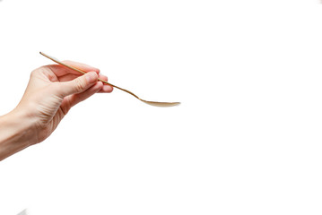 Femal hand holding a golden spoon. Concept. White background, isolated, close up