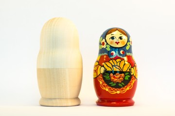 Wall Mural - Colorful and unpaiting nesting russian dolls standing side by side on white