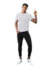 Wall Mural - Full body of Dark skinned man with striped shirt showing and lifting a finger in sign of the best on white background