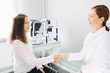 © Peakstock - Handshake with patient, teenage girl's patient at optometrist office. Doctor, consultation and reception of children