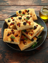 Wall Mural - Homemade Italian focaccia with sun dried tomatoes, black olives and rosemary