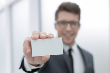 close up.successful businessman showing his business card