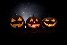 Group Of Halloween Jack O Lanterns At Night With A Rustic Dark Foggy Toned Background