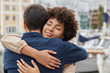 © WHstudio Leushin N - People, togetherness and farewell concept. Affectionate couple in love embarce warm, meet after long departure, stand in port against blurred background, say good bye to each other, express love