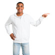 © luismolinero - Dark-skinned young man with white sweatshirt pointing finger to the side and presenting a product while smiling in a confident pose on isolated white background