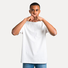 Young african american man showing a sign of closing mouth and silence gesture on isolated background