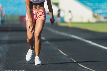 Wall Mural - woman runner hold her injured leg on track