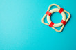 Flat lay of first aid white - red lifebuoy, lifesaver or lifebelt on blue background. Fast emergency rescue on danger catastrophe or abstract business financial economics crisis situation concept.