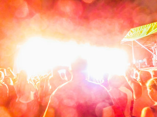  The party, concert concept. Crowd raising their hands and enjoying great rock festival. blur bokeh for background.