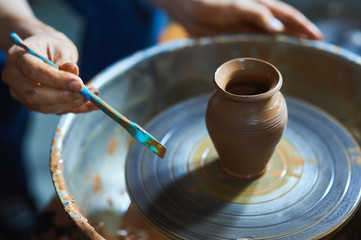 Master class on modeling of clay on a potter's wheel In the pottery workshop