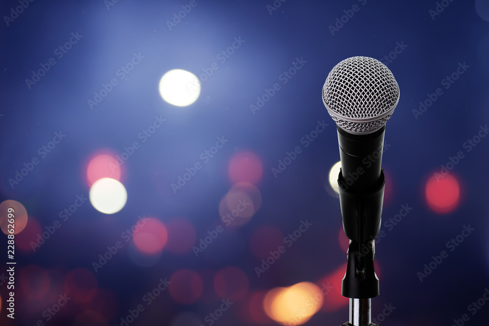 Microphone on stage ..Close up of microphone setting on stand with colorful light bokeh background in conference hall . - obrazy, fototapety, plakaty 