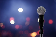 Microphone On Stage ..Close Up Of Microphone Setting On Stand With Colorful Light Bokeh Background In Conference Hall .
