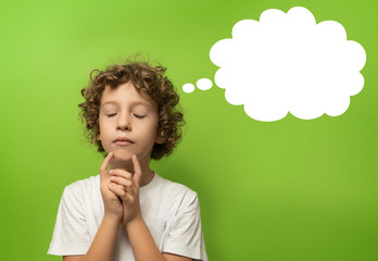 thinking kid - 6 years old child thinking with a thking bubble over his head. Isolated on green background