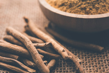 Wall Mural - Ashwagandha / Aswaganda OR Indian Ginseng is an Ayurveda medicine in stem and powder form. Isolated on plain background. selective focus