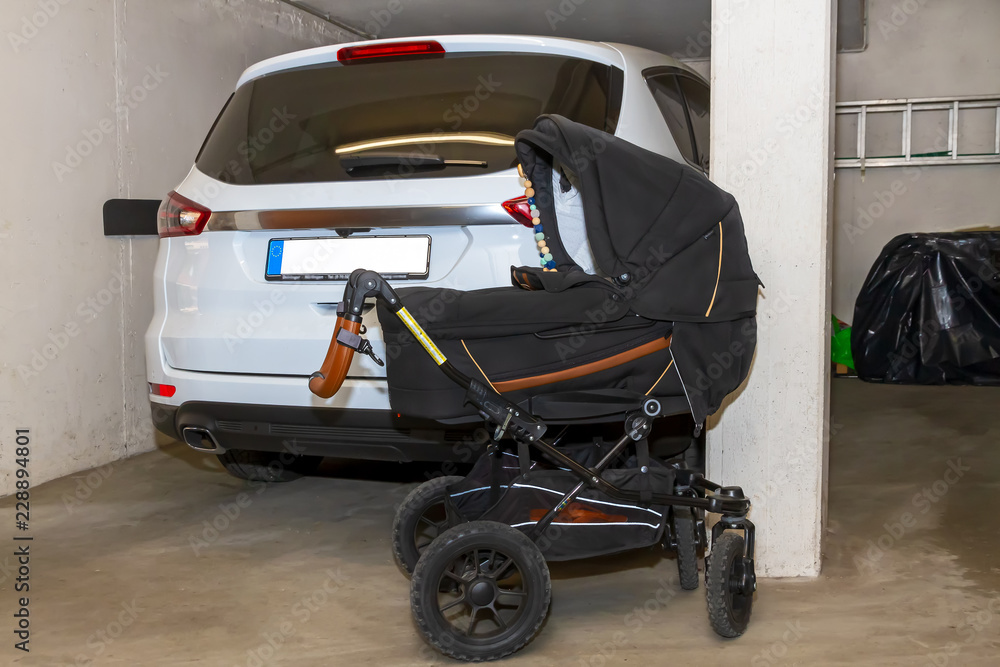 Kinderwagen und Auto in der Garage Stock Photo | Adobe Stock