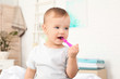 © New Africa - Cute little boy with toothbrush on blurred background