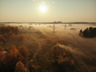 suburban foggy landscape with power lines in russia.