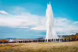 the Strokkur geyser surrounded by people