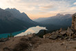 The orange glow of sunset over Peyto Lake in Banff National Park on a cold winter day