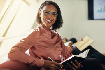 Smiling African businesswoman sitting with colleagues during an