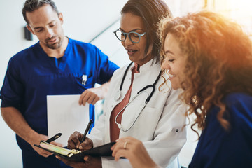 Diverse medical professionals talking together in a hospital cor