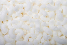 Flat Lay Of Biodegradable Packing Peanuts. Biodegradable Packing Peanuts Are Made From Natural, Nontoxic Sources, Such As Wheat And Corn Starch. They Dissolve In Water And Can Be Put In Compost Piles.