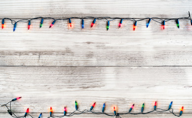 Wall Mural - christmas lights bulb decoration on white wood plank. merry christmas and new year holiday backgroun
