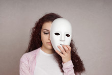 Sad Depressed Young Woman Hiding Her Face Behind Mask