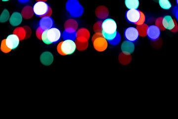 Poster - The colorful bokeh on the blurred natural black background.