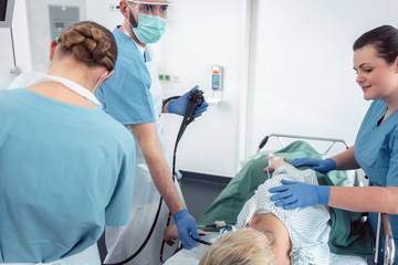 Canvas Print - Team of doctors in hospital at endoscopy examining pictures during gastroscopy 