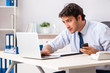 © Elnur - Young handsome businessman working in office