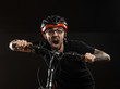 © rotozey - guy in the helmet and glasses on the bike to posing on a black background