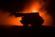© zef art - War Concept. Military silhouettes fighting scene on war fog sky background, World War German Tanks Silhouettes Below Cloudy Skyline At night. Attack scene. Armored vehicles. Tanks battle