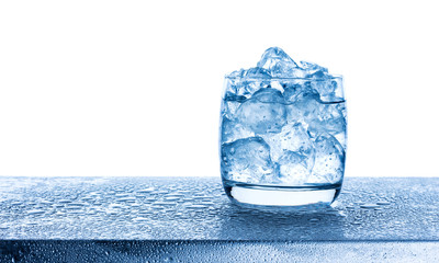 Wall Mural - water with crushed ice cubes in glass on white background