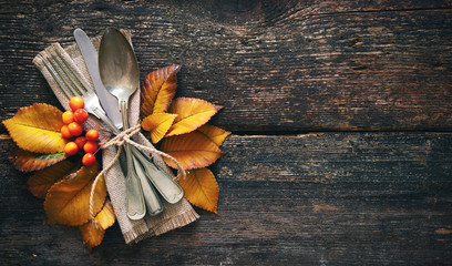 Wall Mural - Autumn background with vintage place setting on old wooden table