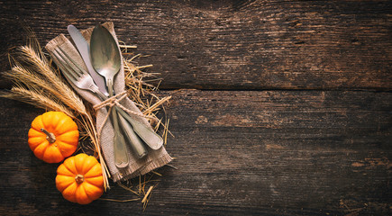 Wall Mural - Autumn background with vintage place setting on old wooden table