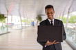 © Ranta Images - Happy African businessman outdoors using laptop computer while smiling