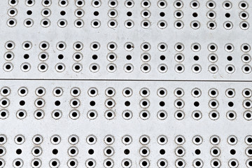 metal surface perforated pattern many round holes gray base design industrial shiny base