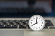 Technology, compter and Time  concept. Close up of vintage round clock on laptop notebook.
