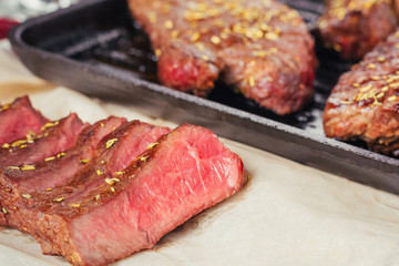 Poster - Close up of sliced grilled steak on frying pan