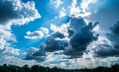 Blue sky background with clouds and sun.