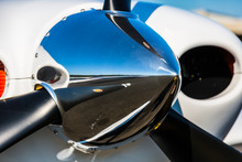 A Close Up Of The Spinner On The Tip Of The Propeller Of A Single Engine Piston Aircraft.  