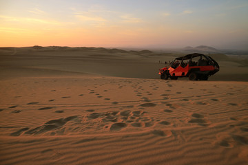 People enjoy dune buggy riding on Huacachina desert in Ica region of Peru, South America  