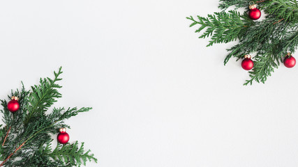 Christmas composition. Coniferous tree branches, balls on pastel gray background. Christmas, winter, new year concept. Flat lay, top view, copy space