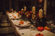 © Olga - Thanksgiving table setting with automnal decorations, pumpkins, glasses and plates. Holidays, catering and hospitality concept.