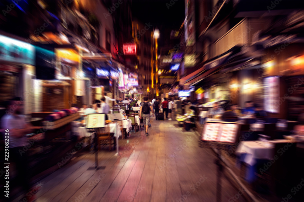 Blurry motion image of people walking on a street in Taksim /Beyoglu area at night in Istanbul. Location is a busy nightlife, shopping and dining district. - obrazy, fototapety, plakaty 