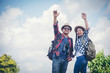 © EKKAPON - Attractive young couple hiking in the forest using binoculars.